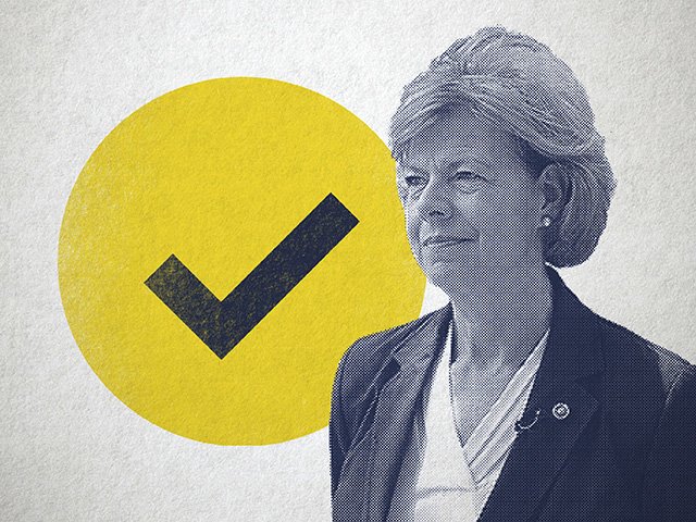 Tammy Baldwin next to a yellow checkmark signifying victory.